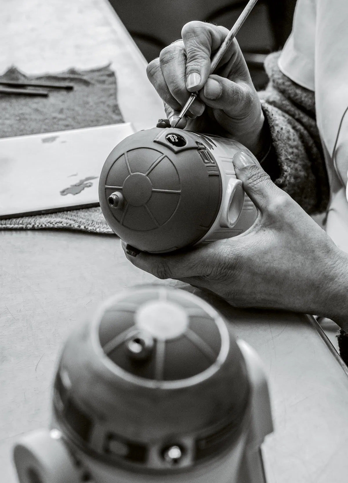 Lladro R2D2™ sculpture featuring detailed ceramic design of the iconic Star Wars droid with blue and white accents.