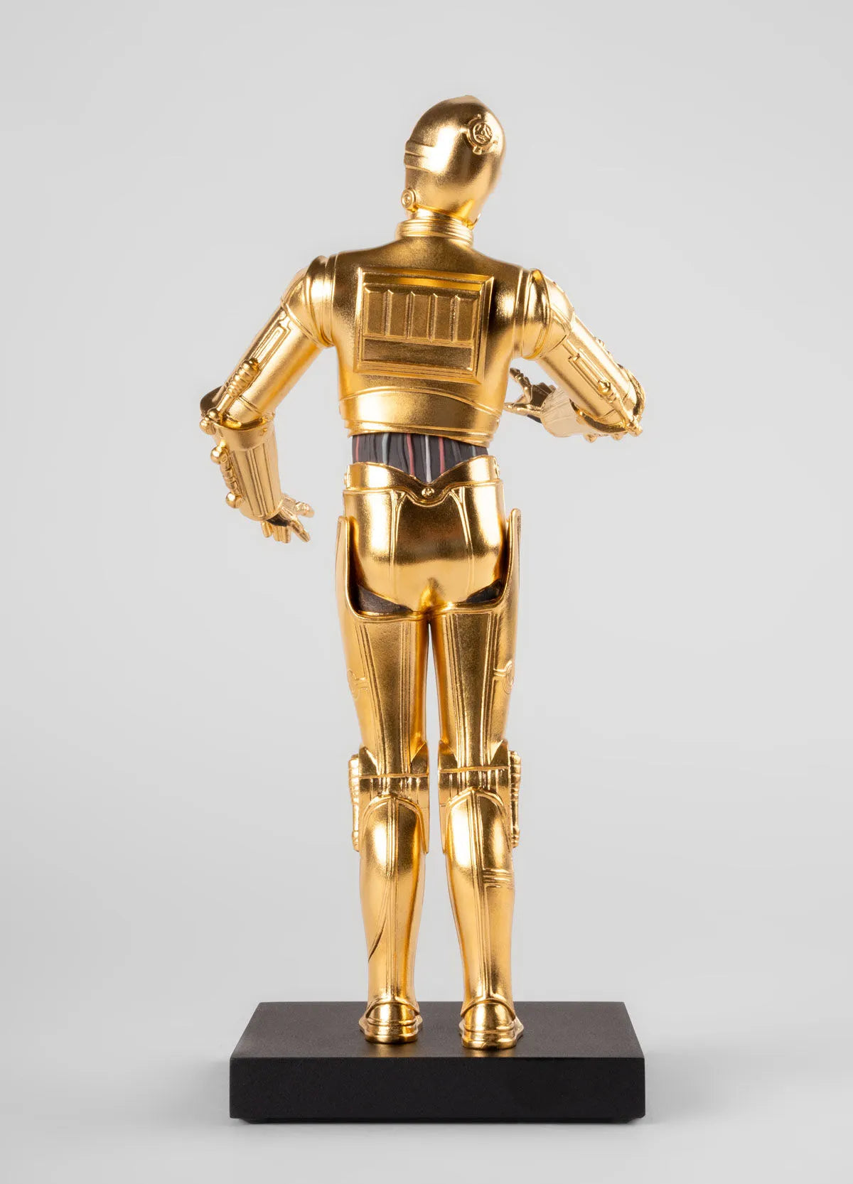 Lladro C3PO™ sculpture depicting the detailed gold and silver robot figure from Star Wars, standing with intricate craftsmanship.