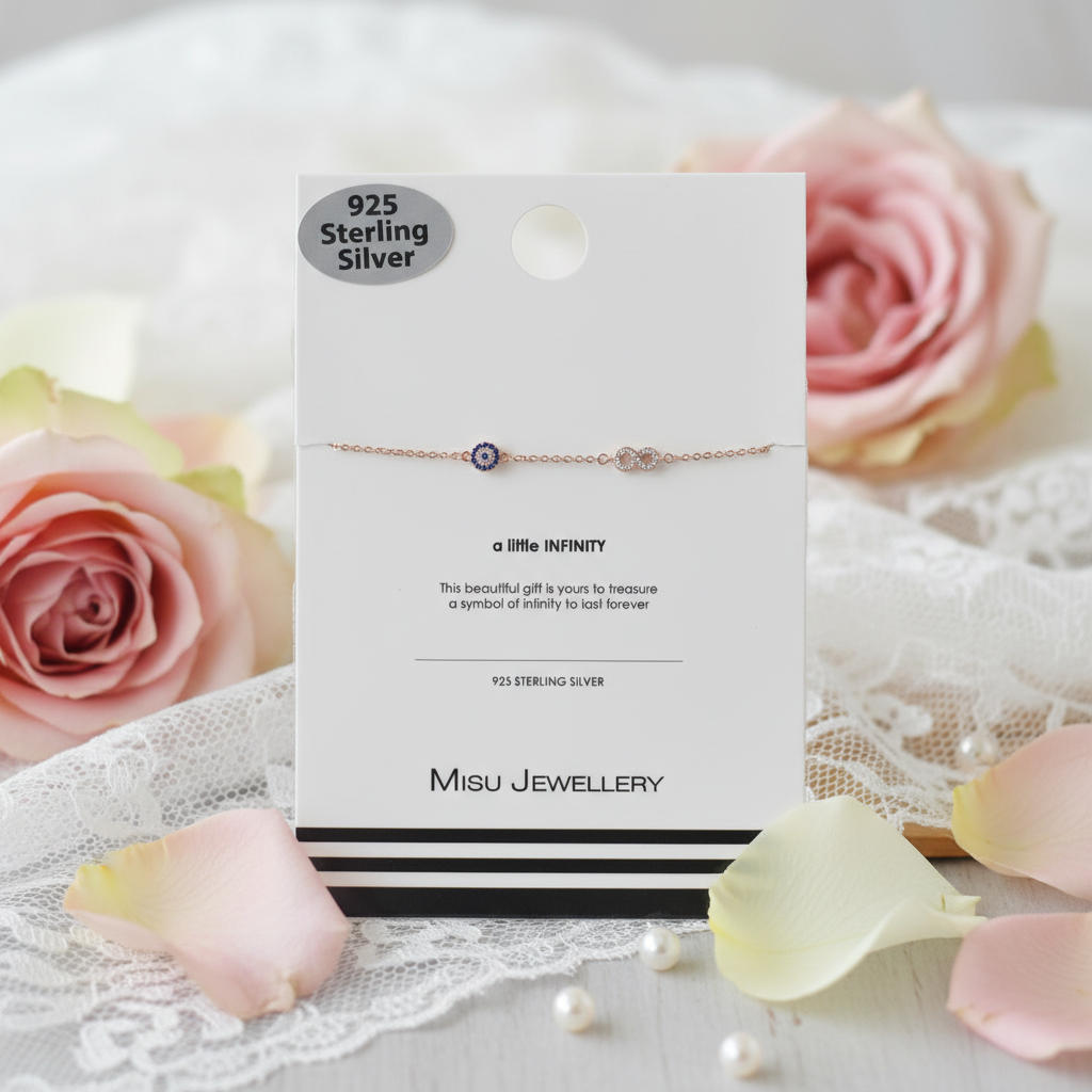 Misu 925 sterling silver rose gold bracelet with evil eye and infinity charm, featuring delicate design and shiny finish.