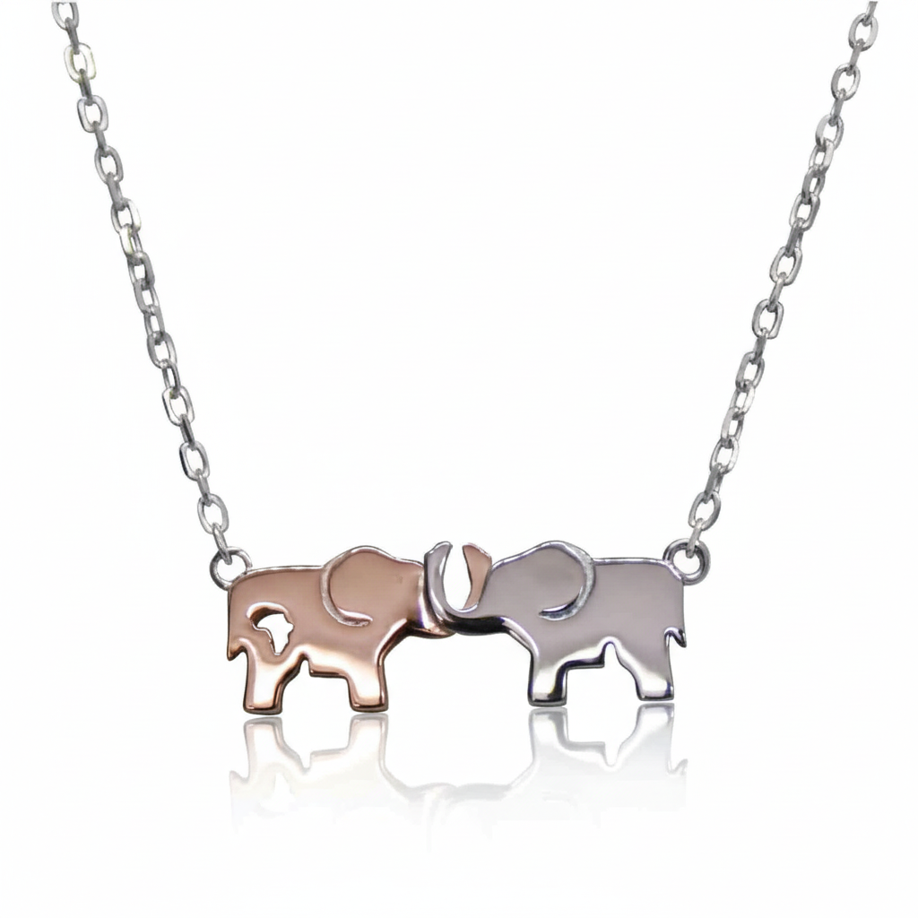 Sterling silver necklace by Misu featuring two-tone elephants holding charms on a delicate chain