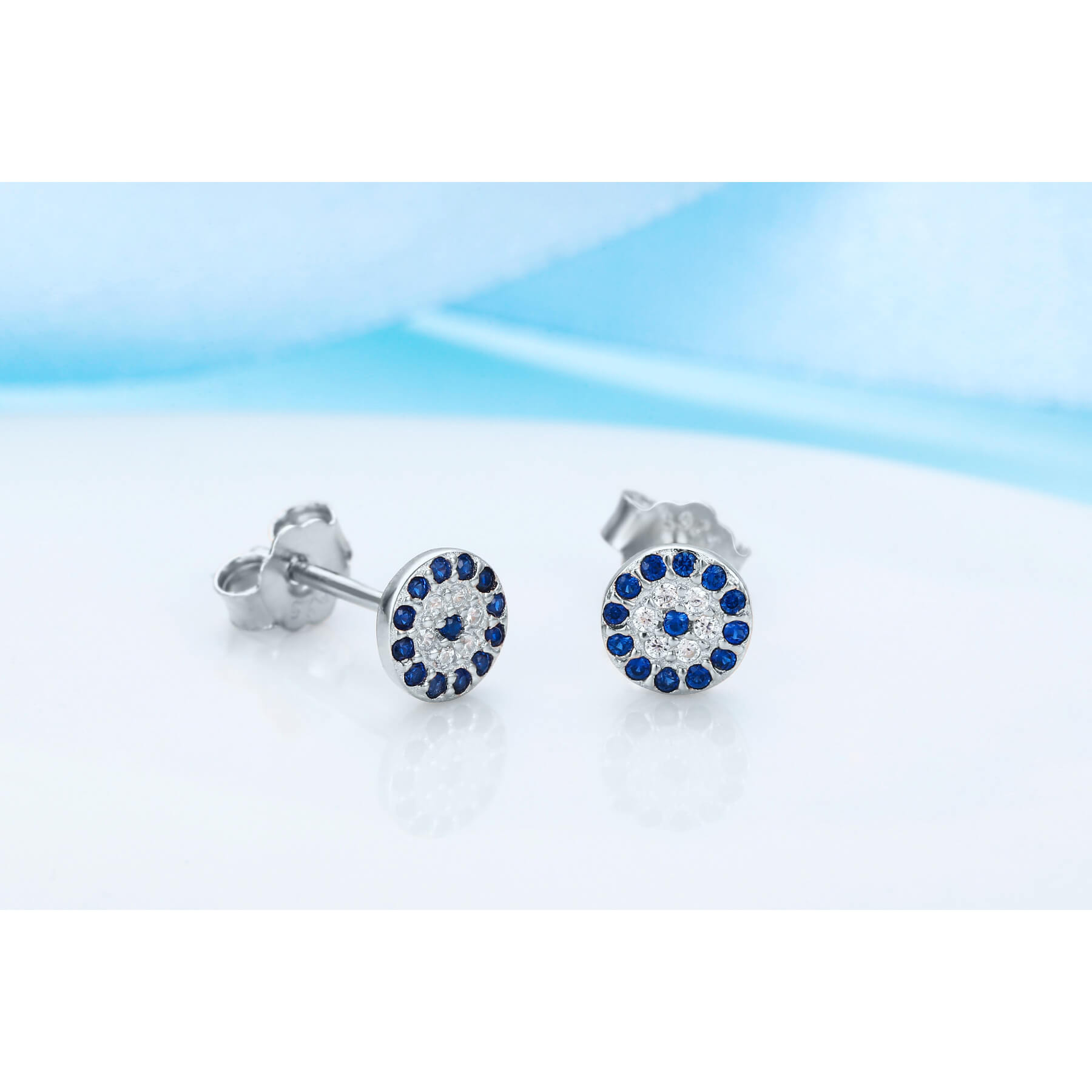 Mini evil eye earrings by Misu, crafted in 925 sterling silver, featuring intricate evil eye design with blue and white accents.