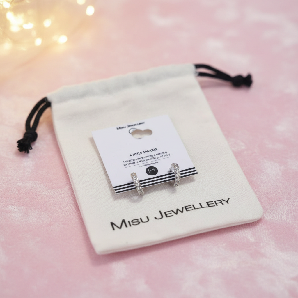 Misu MISU 925 Sterling Silver Huggie Earrings with a sleek, minimalist design and polished finish.