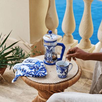 Blue Dolce and Gabbana 1L coffee press by Bialetti with elegant Mediterranean design and glass carafe.
