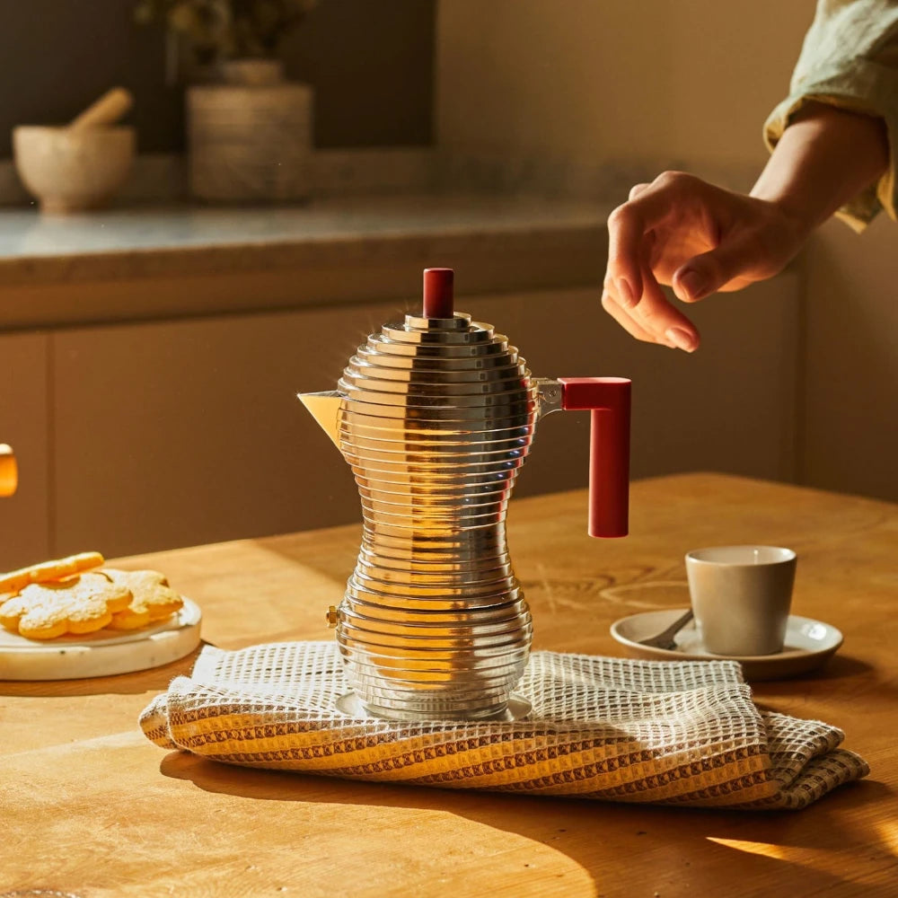 Red Alessi Pulcina 1-cup espresso maker with sleek design and ergonomic handle for brewing rich espresso at home.