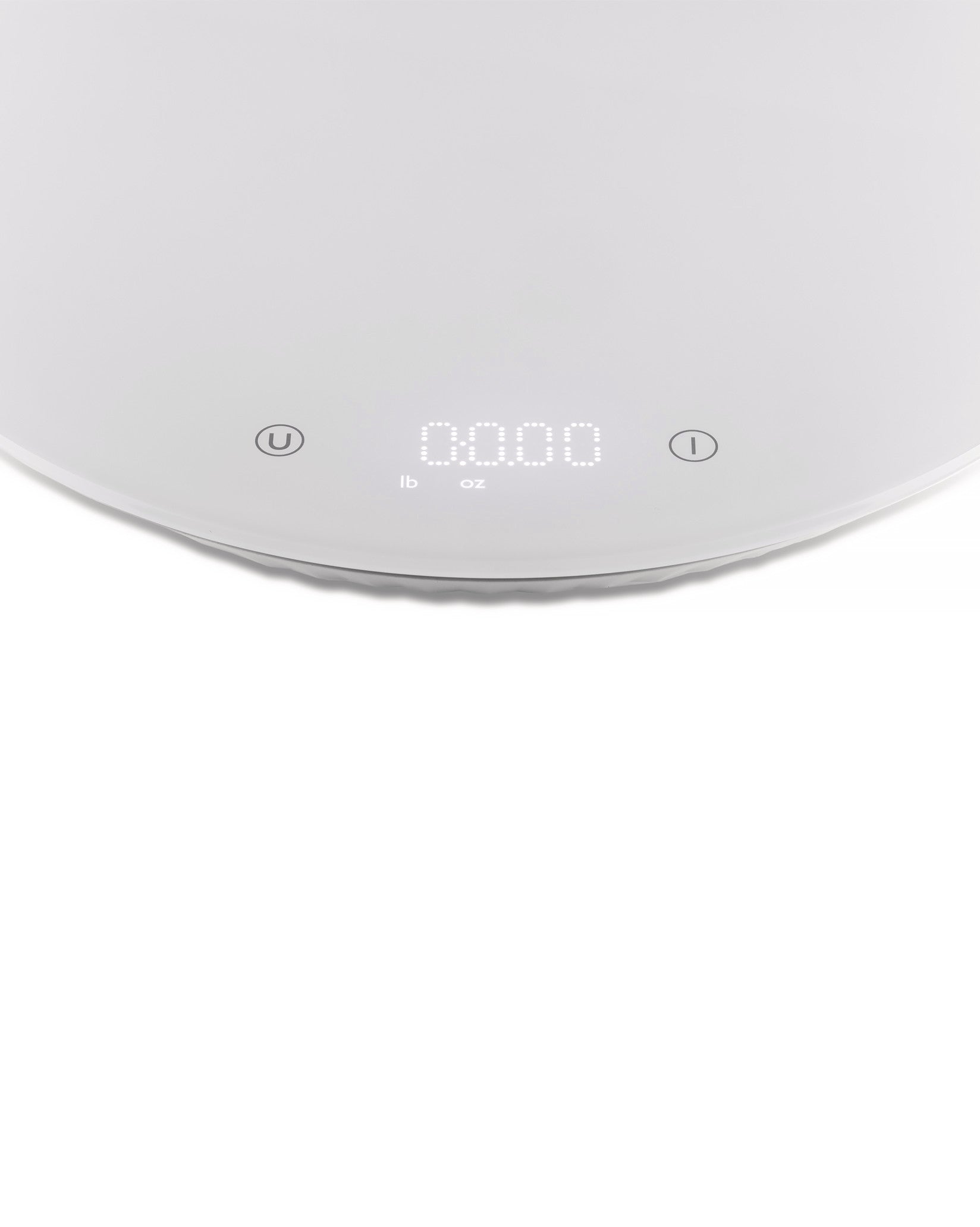 White Alessi Plissé kitchen scale with a textured plissé design and digital display for precise measurements.