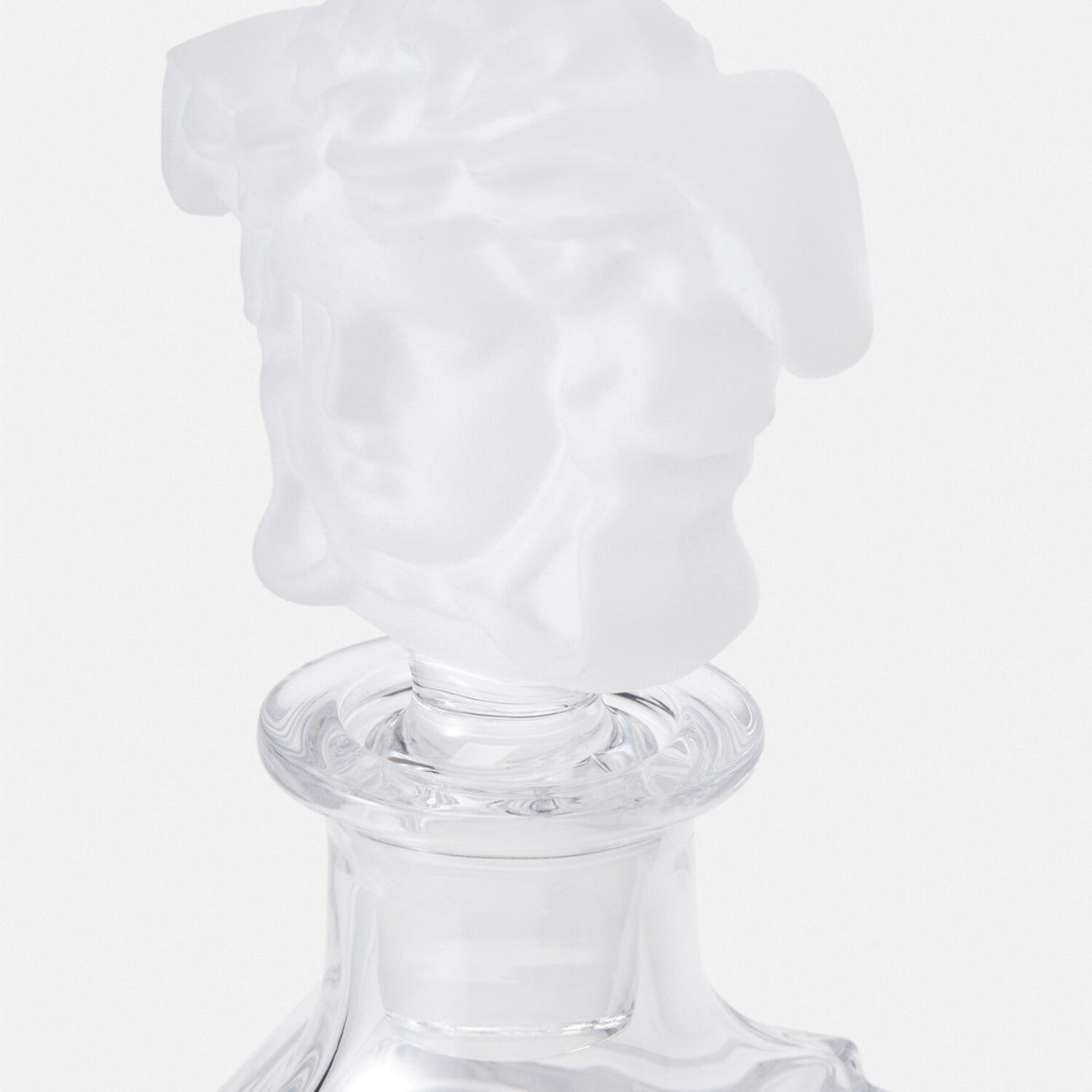 Versace Medusa crystal decanter with intricate design, featuring a luxurious gold-toned stopper and elegant craftsmanship.