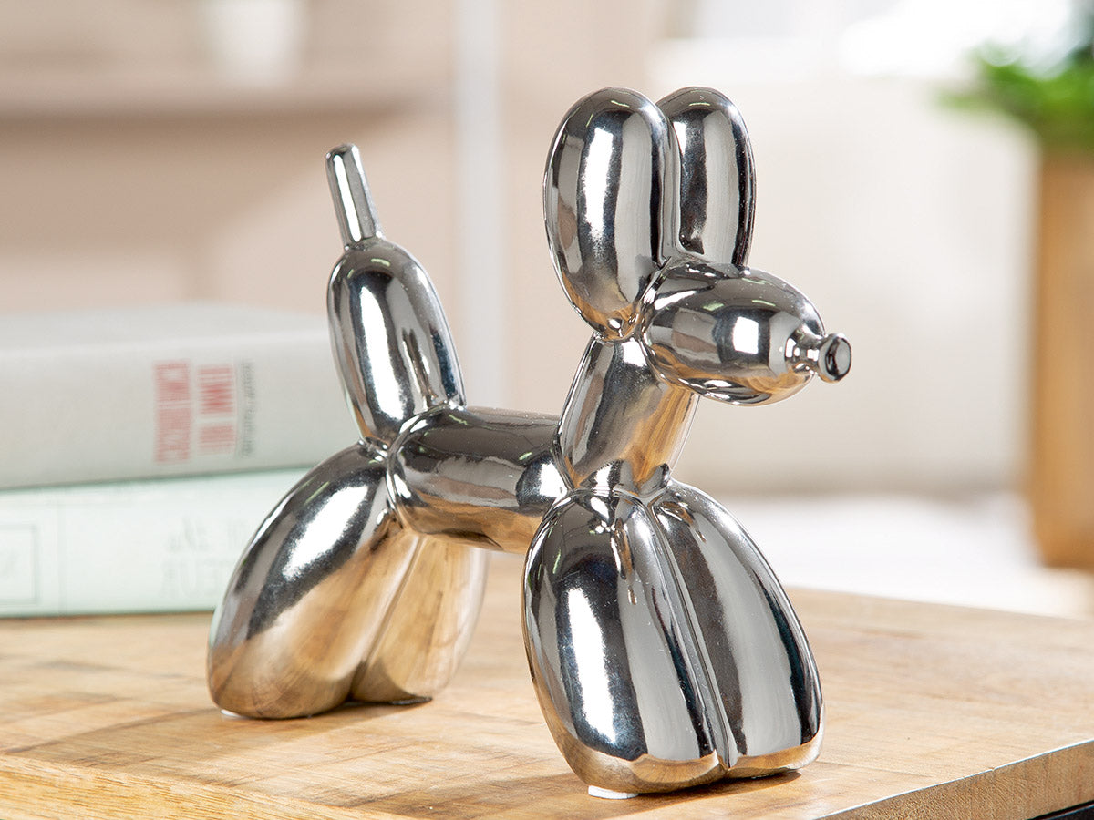 Silver balloon dog figure by Gilde, Poldi style, with shiny metallic finish and playful pose.