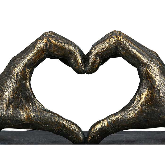 Gilde bronze sculpture of a heart held by two hands, featuring a detailed hand motif and smooth poly bronze finish.
