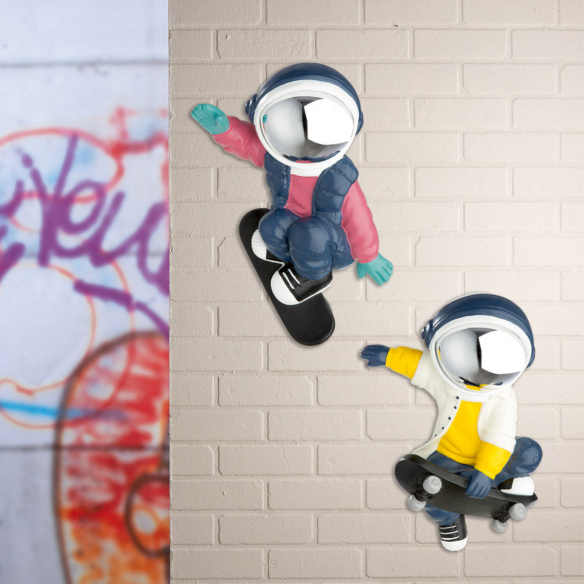 Pink and blue resin Gilde Wall Object astronaut Buzz decor featuring a playful astronaut figure for wall display.