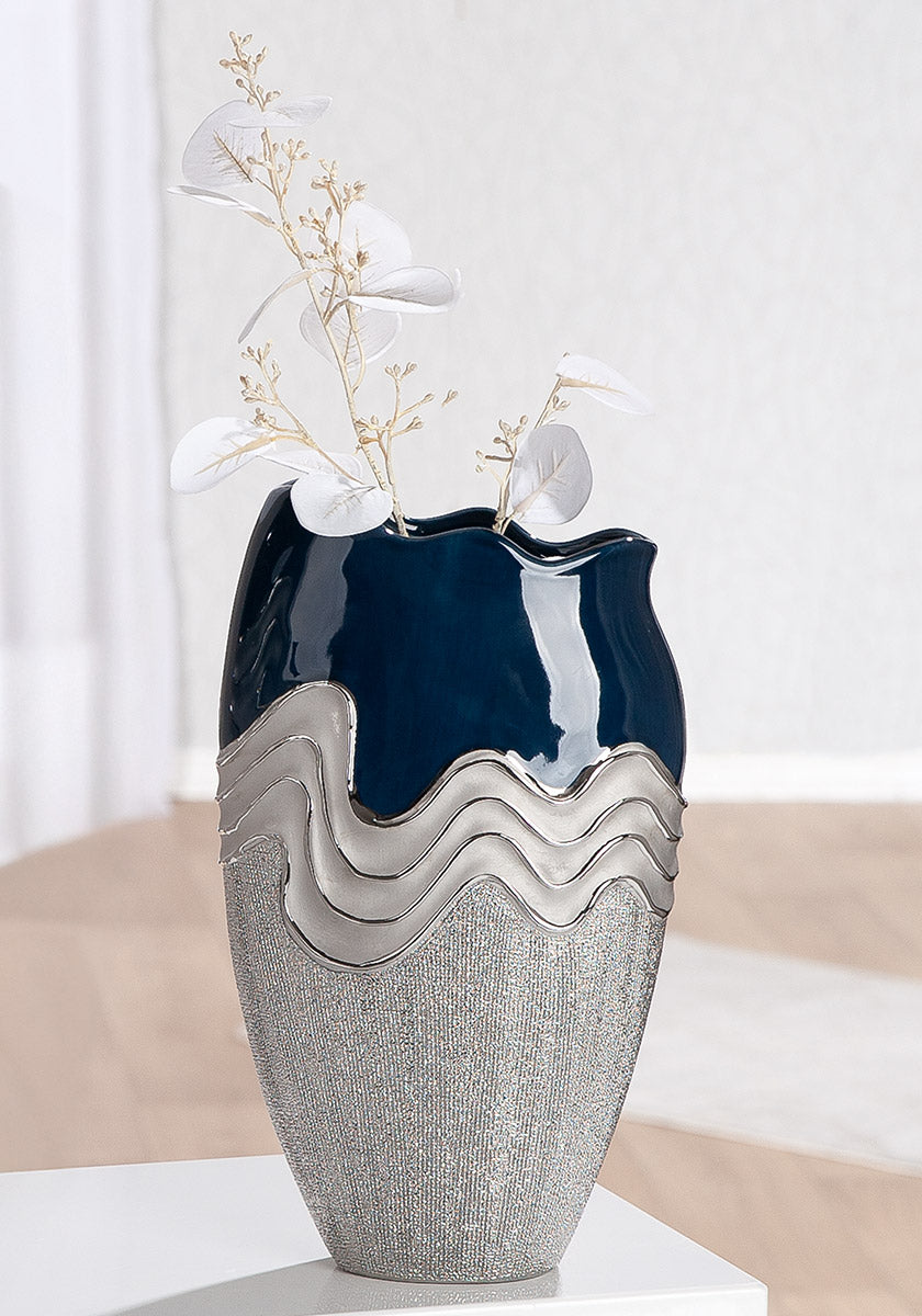 Gilde conical wavy ceramic vase in silver and dark blue with a contemporary, textured design.