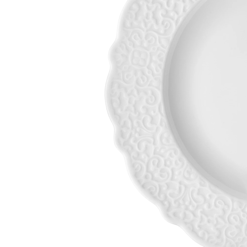 Alessi dressed porcelain dinner plate showing a white plate with a decorative, textured design for elegant table setting