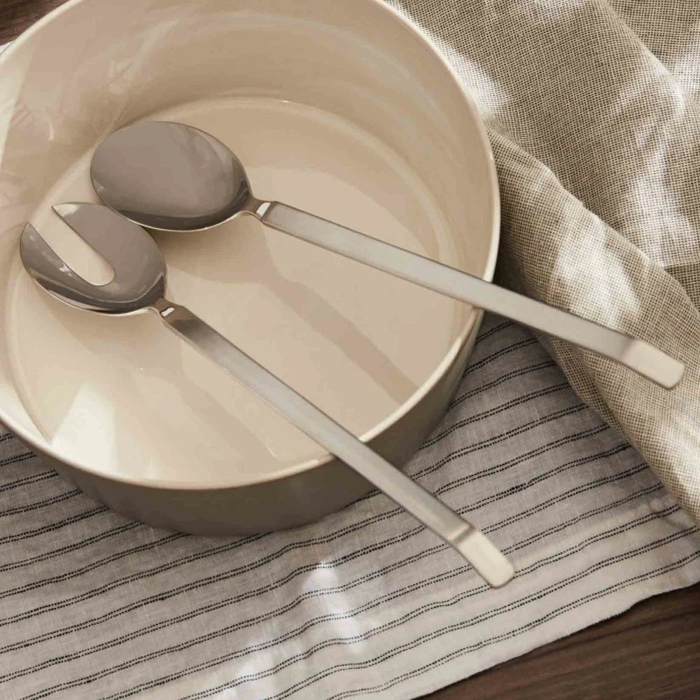 Alessi dry salad set with a sleek ceramic bowl and matching utensils, ideal for serving fresh salads in modern kitchen decor.